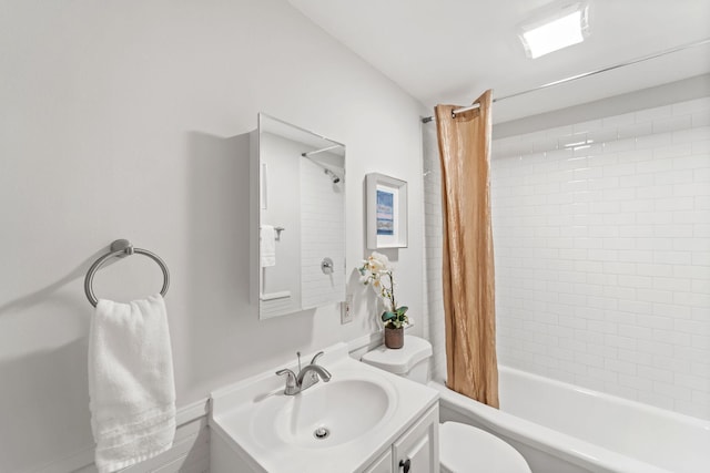 bathroom featuring toilet, vanity, and shower / tub combo