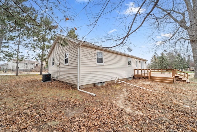 exterior space featuring a wooden deck and central air condition unit