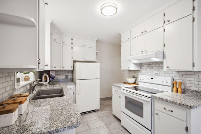 kitchen with under cabinet range hood, decorative backsplash, white appliances, white cabinetry, and a sink