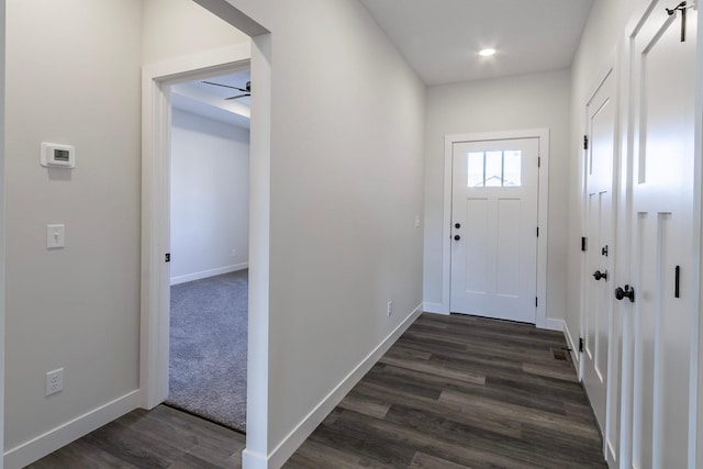 entryway featuring baseboards and dark wood-style flooring