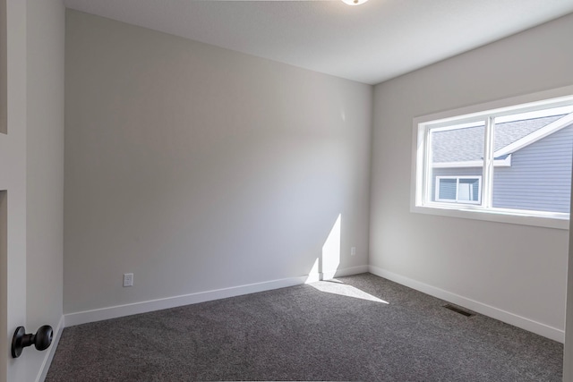 unfurnished room featuring visible vents, baseboards, and carpet floors