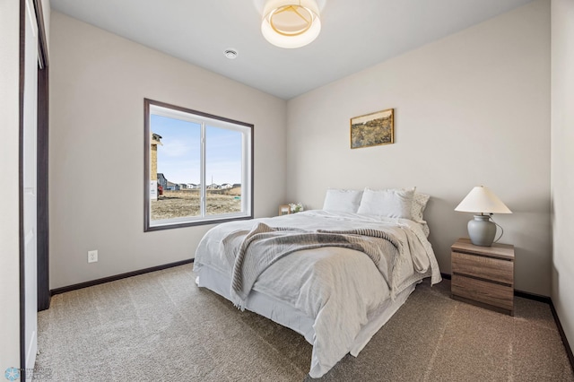 carpeted bedroom featuring baseboards