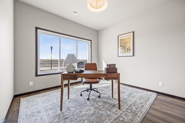 office featuring baseboards and wood finished floors