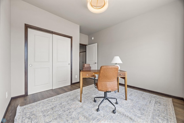 home office with baseboards and wood finished floors