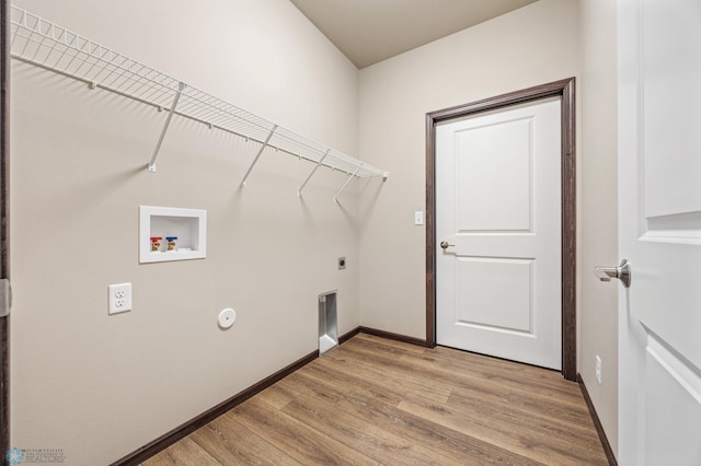 clothes washing area with baseboards, laundry area, hookup for a washing machine, light wood-style floors, and electric dryer hookup