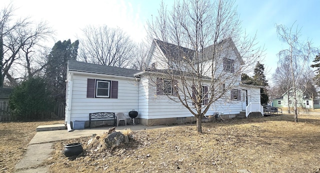 view of front of house with a chimney, roof with shingles, and crawl space