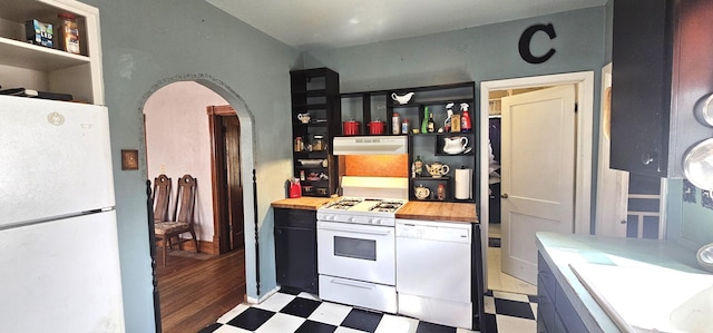 kitchen with white appliances, open shelves, light floors, and under cabinet range hood