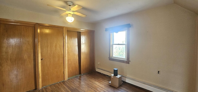 unfurnished bedroom with a baseboard heating unit, lofted ceiling, wood finished floors, and a ceiling fan