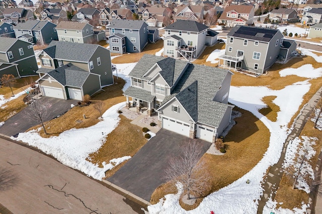 snowy aerial view with a residential view