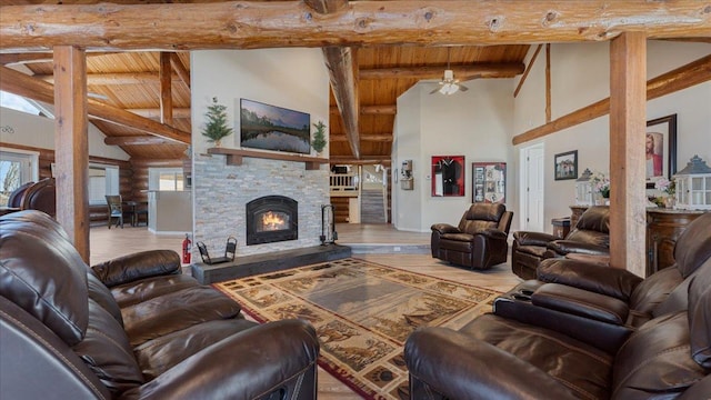 living room featuring beam ceiling, wood finished floors, wooden ceiling, a fireplace, and log walls