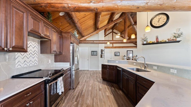 kitchen with light wood finished floors, beam ceiling, a sink, appliances with stainless steel finishes, and wooden ceiling