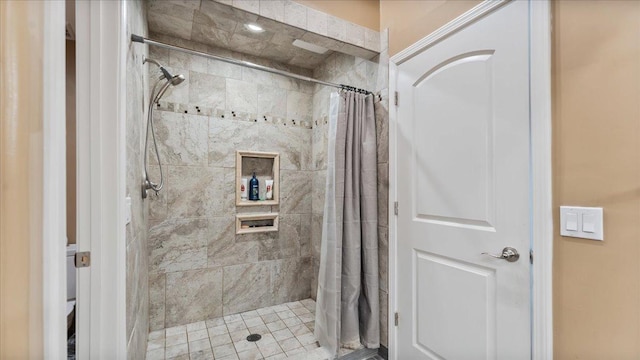 bathroom with tiled shower