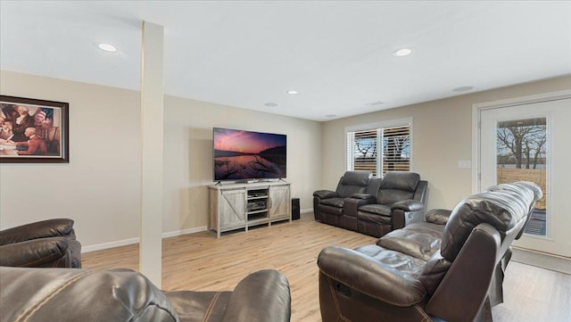 living area featuring baseboards, plenty of natural light, and light wood-style floors