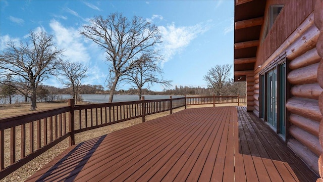 wooden terrace featuring a water view