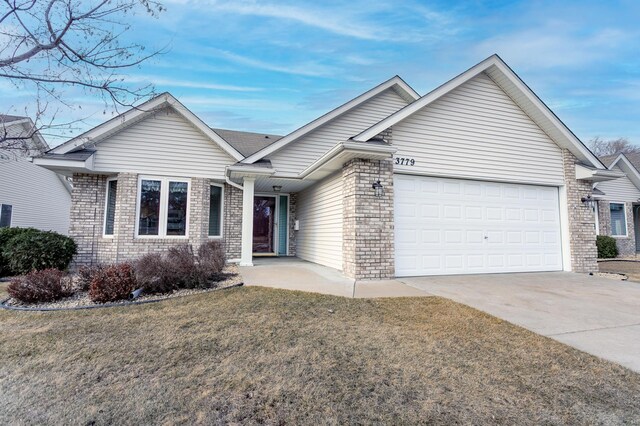 ranch-style house featuring driveway, brick siding, an attached garage, and a front lawn