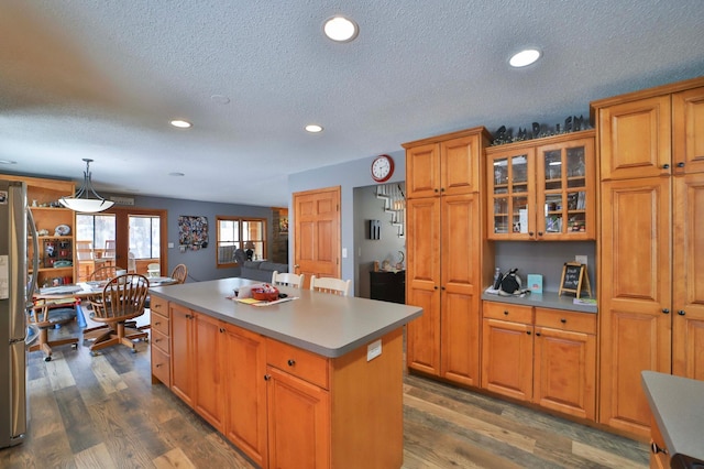 8403 Red Pine Cir, Baxter, MN 56425 - kitchen featuring a kitchen island, recessed lighting, freestanding refrigerator, an office area, and dark wood-style flooring