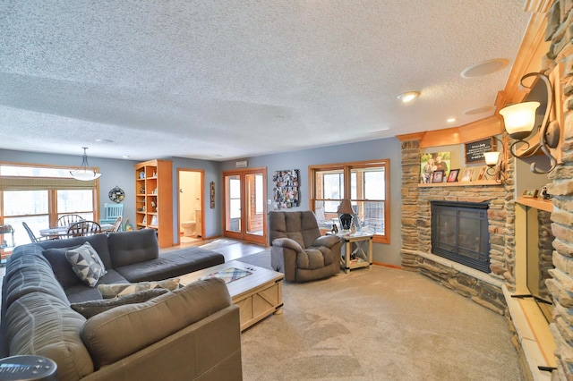 8403 Red Pine Cir, Baxter, MN 56425 - living room with carpet, a fireplace, a textured ceiling, and baseboards