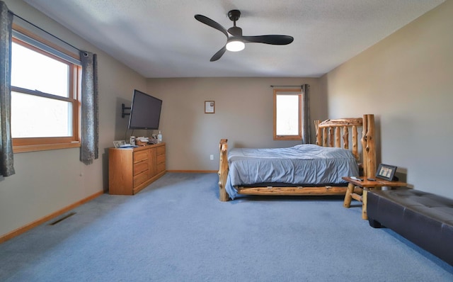 8403 Red Pine Cir, Baxter, MN 56425 - carpeted bedroom featuring multiple windows, baseboards, and a ceiling fan