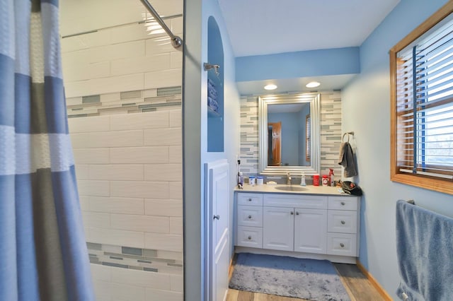 8403 Red Pine Cir, Baxter, MN 56425 - bathroom featuring wood finished floors, a tile shower, and vanity