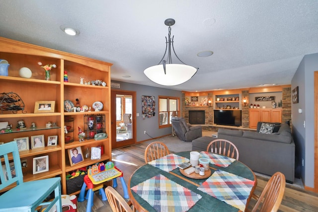 8403 Red Pine Cir, Baxter, MN 56425 - dining area featuring a textured ceiling, wood finished floors, and baseboards