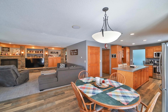 8403 Red Pine Cir, Baxter, MN 56425 - dining space featuring wood finished floors, a textured ceiling, and recessed lighting