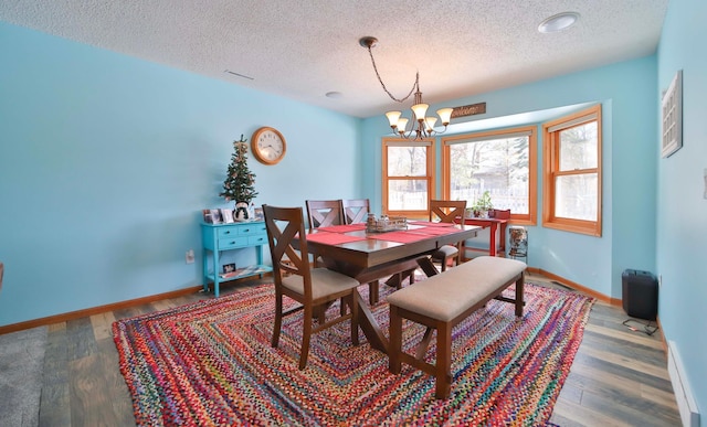 8403 Red Pine Cir, Baxter, MN 56425 - dining space featuring a chandelier, a textured ceiling, baseboards, and wood finished floors