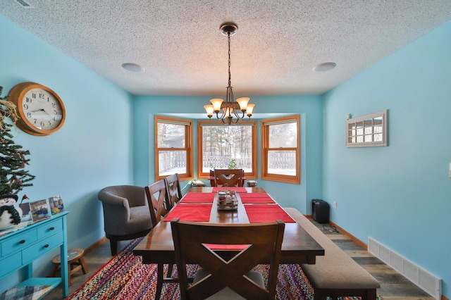 8403 Red Pine Cir, Baxter, MN 56425 - dining space featuring a textured ceiling, a chandelier, wood finished floors, and baseboards