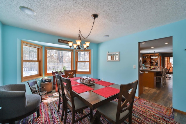8403 Red Pine Cir, Baxter, MN 56425 - dining space with a chandelier, a textured ceiling, and wood finished floors