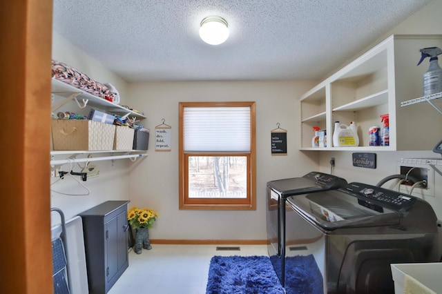 8403 Red Pine Cir, Baxter, MN 56425 - laundry area with washing machine and clothes dryer, a textured ceiling, and baseboards