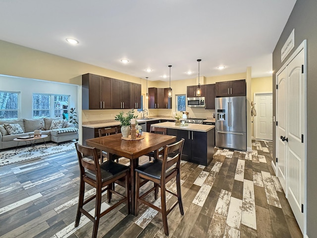 dining space featuring recessed lighting and dark wood-type flooring