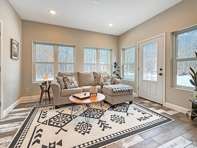 living area featuring a wealth of natural light, baseboards, wood finished floors, and recessed lighting