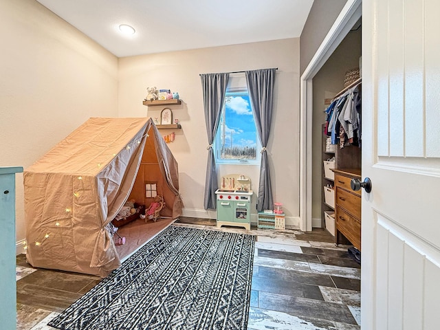 rec room with wood finished floors and baseboards