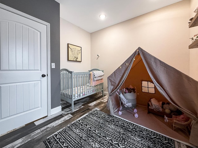 bedroom featuring baseboards and wood finished floors