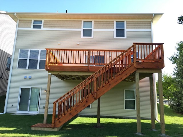 rear view of house featuring a yard, a deck, and stairway