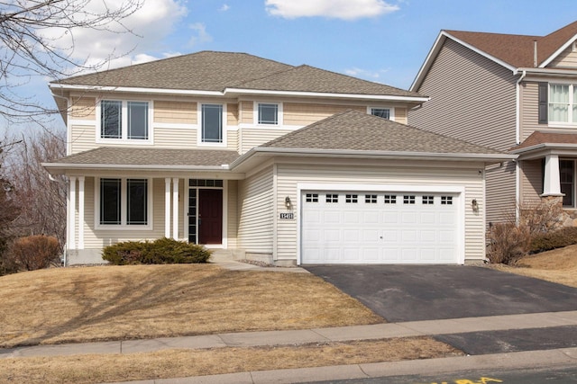 view of front of property with aphalt driveway, a garage, and roof with shingles