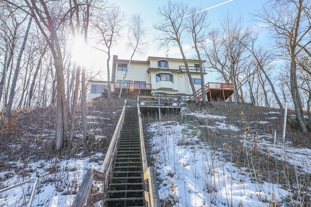 snow covered house with stairs