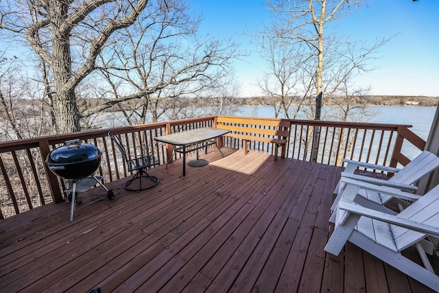 wooden deck featuring grilling area and a water view