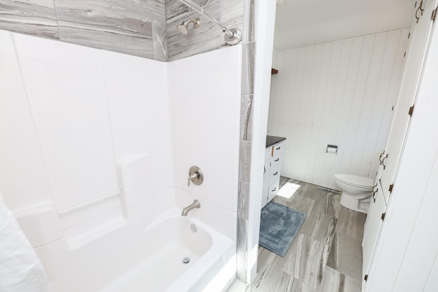 bathroom with toilet, vanity, and  shower combination