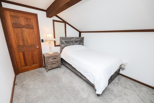 bedroom with light colored carpet, lofted ceiling with beams, and baseboards