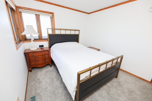 bedroom with baseboards, light colored carpet, and ornamental molding