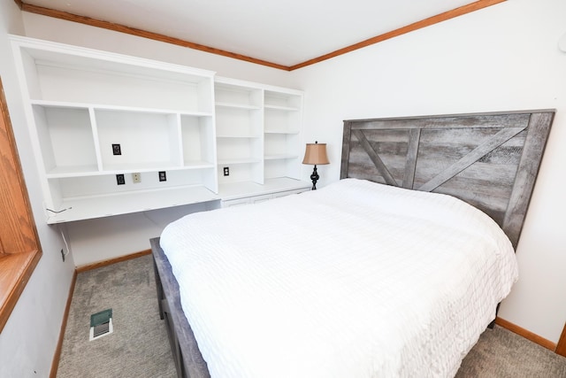 bedroom with crown molding, carpet flooring, baseboards, and visible vents