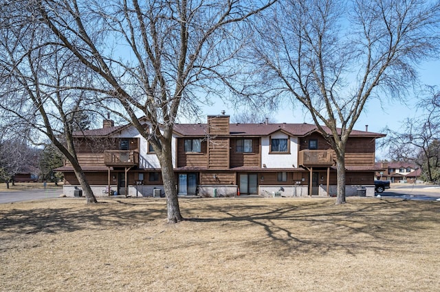 12617 Alder St NW, Coon Rapids, MN 55448 - view of front of property with a balcony and a chimney