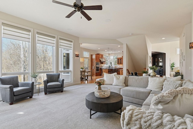 living room featuring recessed lighting, light colored carpet, and a ceiling fan