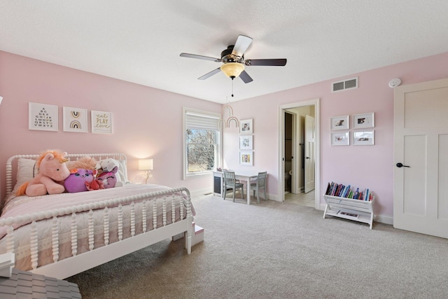 bedroom featuring visible vents, a textured ceiling, carpet flooring, baseboards, and ceiling fan