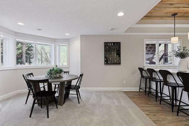 dining area with a wealth of natural light, recessed lighting, baseboards, and wood finished floors