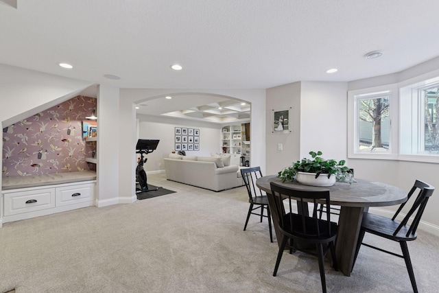 dining space featuring arched walkways, recessed lighting, light carpet, and baseboards