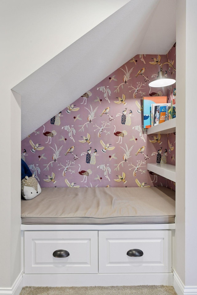 interior space with lofted ceiling and baseboards