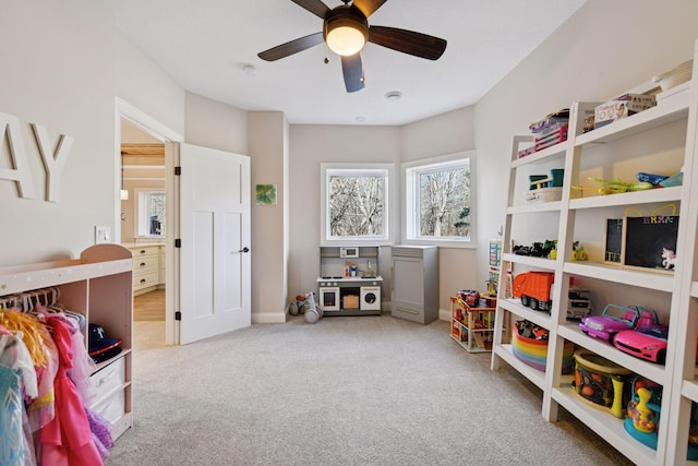 recreation room featuring baseboards, a ceiling fan, and carpet flooring