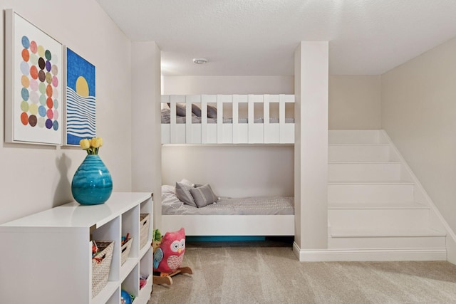 carpeted bedroom featuring a textured ceiling