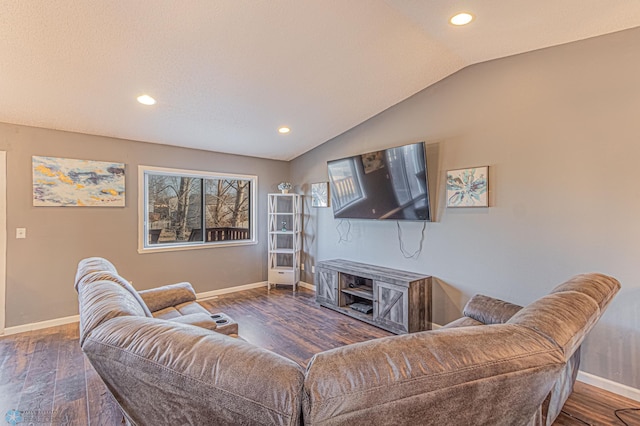 living area featuring baseboards, lofted ceiling, and wood finished floors